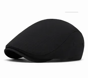 Detailed close-up of a structured black beret flat cap with subtle twill fabric texture