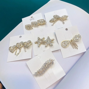 Set of six gold-plated alloy hair clips with sparkling rhinestones in various shapes