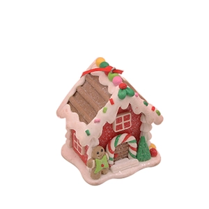 Detailansicht eines Lebkuchenhauses aus Fimo mit weißem Zuckerguss und bunten Akzenten