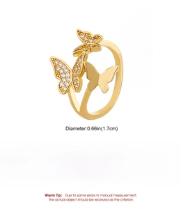 Detailed view of triple butterfly ring in gold-plated copper with sparkling cubic zirconia