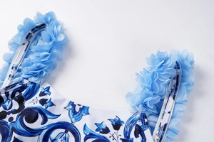 Detail of blue floral print swimsuit with 3D petal chiffon shoulder straps