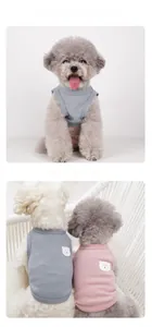 Detail of pink and grey waffle knit pet vests with cute bear patches on dogs