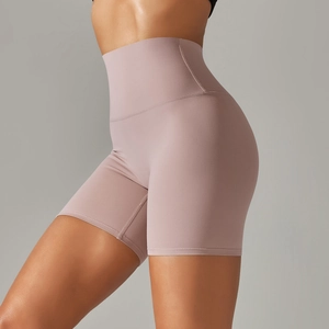 Side view of high-waisted yoga shorts in dusty pink with elastic tummy control