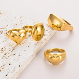 Set of minimalist gold stainless steel rings with heart and oval shapes on stone