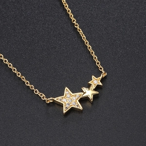 Elegant gold necklace with sparkling zircon star pendant on a sophisticated black texture