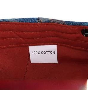 Macro shot showing 100% cotton material and inner lining of a blue plaid newsboy cap