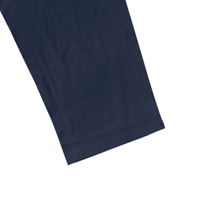 Detail of double-stitched hem and navy blue linen fabric texture for men's beach set