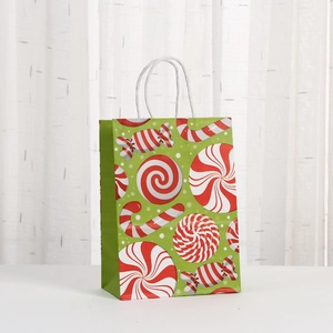 Christmas gift bag with green background and red candy patterns made of kraft paper