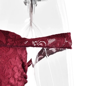 Macro shot of burgundy lace shoulder strap detail on a strapless dress design