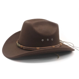 Detail of dark brown cowboy hat showing metallic eyelets and braided band decoration