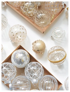 Detailed view of champagne lace and pearl dot Christmas balls with glitter textures