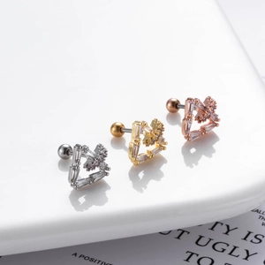 Macro shot of dragonfly moon stud earrings in silver, gold, and rose gold with zircon stones