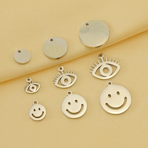 9-piece set of silver stainless steel pendants with disk, eye, and smiley face designs