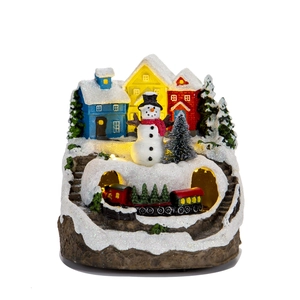 Lighted musical Christmas village house with colorful cabins and snowman on white background