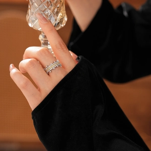 Detail of micro-pave zircon crown ring in gold and silver finish on finger