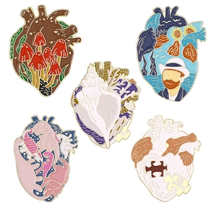 Collection of creative anatomical heart enamel pins with colorful artistic designs