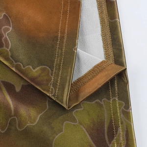 Detailed macro view of ginkgo leaf print fabric with premium overlock stitching