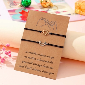 Handmade woven sun and moon promise bracelets set on a pinky promise display card