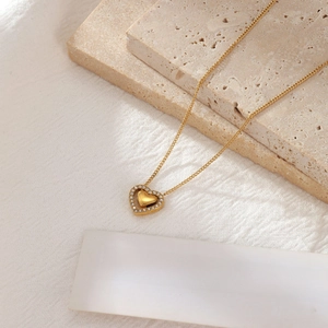 Elegant gold double heart pendant necklace with sparkling crystals on minimalist chain