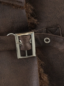 Detail of brown faux leather jacket featuring silver metal buckle and warm faux fur lining