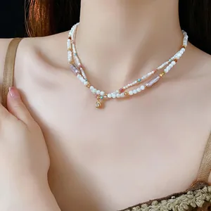 Double-layered beaded necklace with white pearls and gold waterdrop zircon pendant