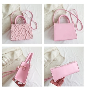 Detail view of pink quilted tote bag showing textured fringe fabric and leather base