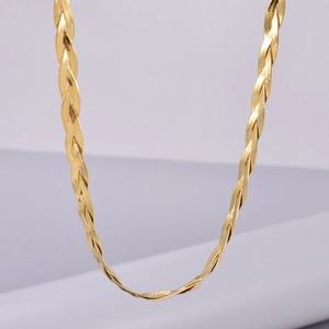 Detailed macro view of triple-layered braided flat snake bone chain necklace in 18K gold finish