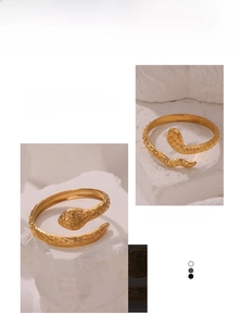 Detail of vintage gold plated snake ring showing intricate scale texture and open design