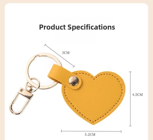 Detail showing dimensions of yellow heart leather keychain with gold hardware