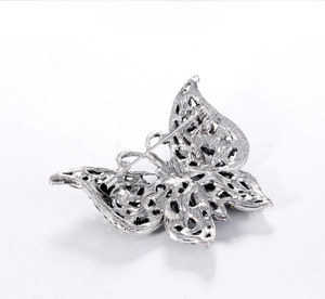 Detail view of the silver butterfly brooch back showing the pin closure and hollow design