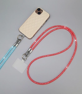 Detail view of red and blue rhinestone braided phone lanyards with metal buckles and patch
