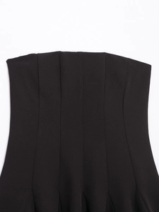 Detail of vertical seam craftsmanship and textured fabric on this black off-shoulder dress
