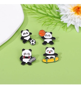 Close-up of cute panda sports enamel pins featuring basketball and soccer on green background