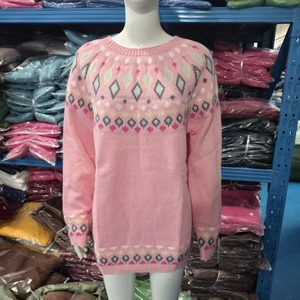 Detail of pink knitted sweater featuring geometric argyle pattern on cuffs and hem