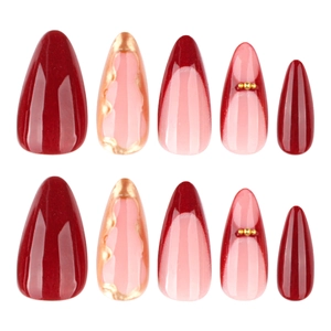 Deep red almond press-on nails with marble texture and golden bead accents in set