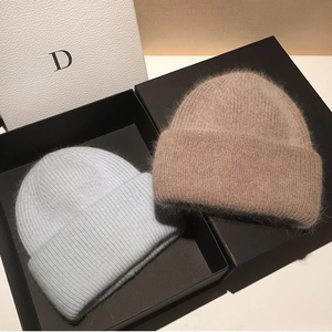 Premium fluffy rabbit fur knit beanies in light blue and beige with a cozy texture