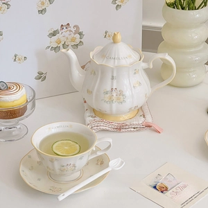 Detail of camellia ceramic tea set with teapot and cup in vintage French pastoral style