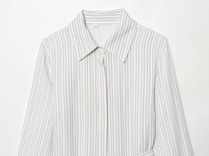 Macro detail of the collar, fine striped fabric texture, and size XS tag on shirt