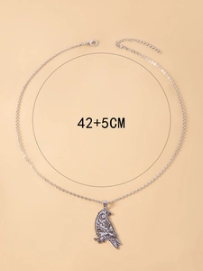 Close-up of silver crow pendant with moon patterns and 42+5cm chain size details