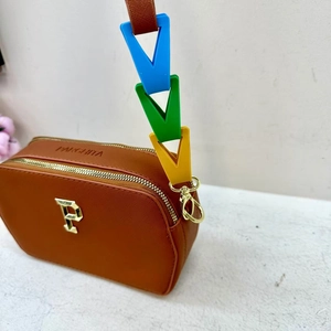 Detail of brown crossbody bag with colorful chunky chain strap and golden F logo