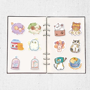 Detail showing 12 cute animal and dessert waterproof stickers on a ring binder notebook