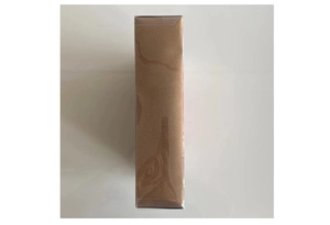 Detail view of sealed bronze gold gift box with protective plastic shrink wrap
