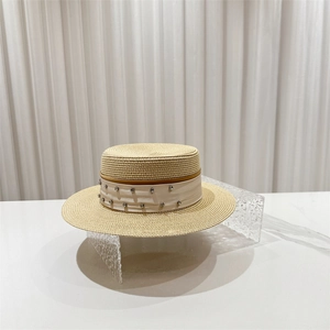 Detailed macro of boater straw hat with elegant rhinestones and cream ribbon