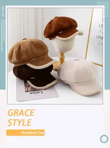 Detail view of suede newsboy caps in earth tones with fuzzy faux fur trimming details