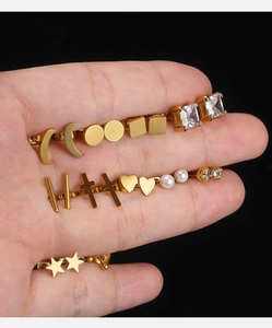 Detailed view of 18K gold plated earring set featuring moon, star and pearl studs