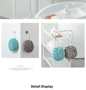 Detail of soft hanging chenille hand towel balls in grey and green for bathroom