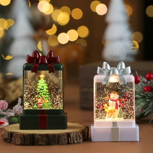 Close-up of sparkling Christmas gift-box water lanterns with swirling glitter and warm LED lights