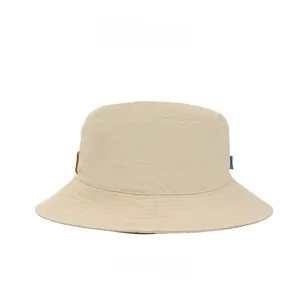 Side view detail of beige wide brim sun hat with woven label and parallel stitching