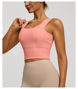 Detail view of the wide shoulder straps and side stitching on this pink sports bra