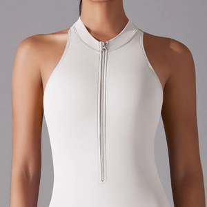 Close-up of white high-neck yoga bodysuit with functional metal zipper detail